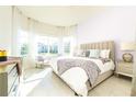 Bright and airy main bedroom with a large window and decorative accents at 13401 Panama Beach Ct, Orlando, FL 32827