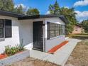 Front entrance and walkway leading up to the entry door and a garden area with mulch at 1382 Wright St, Daytona Beach, FL 32117