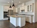 Modern kitchen with a large center island, stainless steel appliances, and bright white cabinetry at 15052 Mayberry Dr, Winter Garden, FL 34787