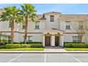 Exterior of a beautiful two-story condo building featuring a tile roof, and mature landscaping at 1569 Plunker Dr, Davenport, FL 33896