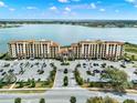 Aerial view of the luxury condos shows lush landscaping, a parking area, and scenic lake views at 16300 County Road 455 # 201, Montverde, FL 34756