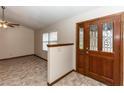 Open foyer with a beautiful door and tile flooring at 1811 Springwood Ln, Deltona, FL 32725