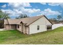 The home's rear exterior showcasing a large backyard and sunroom at 1811 Springwood Ln, Deltona, FL 32725