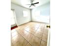 Bright bedroom with ceramic tile floors, ceiling fan and natural light from the large windows at 2815 W Orange Blvd, Kissimmee, FL 34741