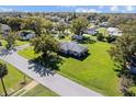 Areal view of a single-story home with large lawn, mature trees, and quiet neighborhood at 522 Wisconsin Ave, St Cloud, FL 34769