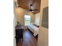 Cozy bedroom with ample natural light, dark wood floors, and comfortable bed at 630 3Rd Street St, Oviedo, FL 32765