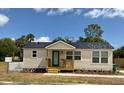 Charming single-story home with a welcoming porch and well-manicured lawn at 630 3Rd Street St, Oviedo, FL 32765