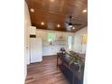 Bright kitchen featuring white cabinets and modern appliances with a ceiling fan at 630 3Rd Street St, Oviedo, FL 32765