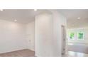 Hallway featuring carpet and a view of the living room and open floor plan at 6627 Lullaby Way, Mascotte, FL 34753