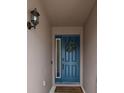 Beautiful blue front door adorned with a wreath, adding a welcoming touch to the home's entrance at 704 Hyperion Dr, Debary, FL 32713