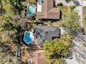 Aerial view of a home with a backyard pool and patio area surrounded by trees at 7448 Grand Ct, Winter Park, FL 32792