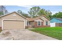 The exterior showcases a convenient attached garage, and a well-kept lawn at 1010 Corbin Ct, Oviedo, FL 32765