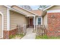 Inviting front porch with classic details, a brick facade, and a sheltered entrance at 1010 Corbin Ct, Oviedo, FL 32765