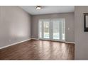 Bright living room with wood floors and elegant glass doors leading to the pool area at 1010 Corbin Ct, Oviedo, FL 32765