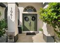 Inviting front entrance with double doors, potted plants, and a welcome sign at 1061 New Castle Ln, Oviedo, FL 32765