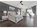 Elegant main bedroom with hardwood floors, stylish furnishings, and a sliding glass door to the pool at 11327 Ledgement Ln, Windermere, FL 34786