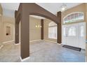 Open foyer with high ceilings, decorative columns, tile flooring, and a view of the front door at 1195 Legendary, Clermont, FL 34711