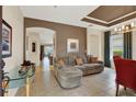 Open-concept living room with tile floors, a decorative ceiling, an arched doorway, and comfortable seating at 123 Avenham Drive, Deland, FL 32724