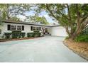 Beautiful home exterior with a two-car garage and a long driveway at 1307 Lindenwood Ln, Winter Park, FL 32792