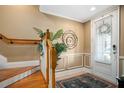 Entryway featuring hardwood stairs, neutral paint, modern lighting and front door at 1389 Chatfield Pl, Orlando, FL 32814