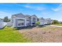 A spacious single-story house with a well-maintained lawn and a side yard with white fencing at 1409 Golf Course Pkwy, Davenport, FL 33837