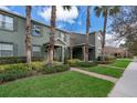 Townhome showcases lush landscaping, palm trees, brick walkway, and manicured lawn in a desirable community at 14849 Driftwater Dr, Winter Garden, FL 34787