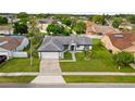 Overhead view of a well-kept home featuring verdant lawn and concrete driveway at 14923 Day Lily Ct, Orlando, FL 32824