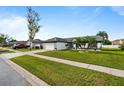 Lovely single-story home featuring manicured lawn and palm tree landscaping at 14923 Day Lily Ct, Orlando, FL 32824