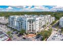 Wonderful aerial view of the condo building surrounded by lush greenery and a cityscape in the distance at 2305 Edgewater Dr # 1701, Orlando, FL 32804