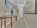 Stylish hallway featuring neutral-colored walls, tile flooring, and an elegant console table with lamps at 2305 Edgewater Dr # 1701, Orlando, FL 32804