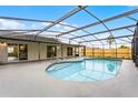 Relaxing screened-in pool area with a sparkling pool and a spacious patio, perfect for outdoor entertaining at 2335 Montano St, Deltona, FL 32738