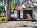 Attractive one-story home with a mature shade tree, paved driveway, and attached garage at 2600 Musselwhite Ave, Orlando, FL 32804