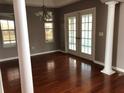 Inviting dining room with gleaming hardwood floors, elegant chandelier, and views to lanai at 2628 Caribe Dr, The Villages, FL 32162