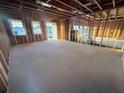 Large unfinished room with exposed beams, wood framing and concrete floor, waiting for final touches at 30117 Misty Pines Rd, Mount Dora, FL 32757