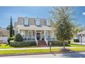 Charming two-story home showcasing a covered front porch, brick steps, and lovely lawn at 4268 Ethan Ln, Orlando, FL 32814