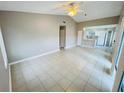 Spacious living room with tile flooring leading to an open kitchen, creating an inviting atmosphere at 4439 Pinebark Ave # 47-4, Orlando, FL 32811