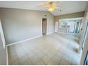 Open concept living area, with tile flooring, that flows into the kitchen at 4439 Pinebark Ave # 47-4, Orlando, FL 32811