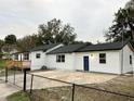 View of the back of the house featuring a newly installed back door and concrete parking pad at 4900 Grand Ave, De Leon Springs, FL 32130