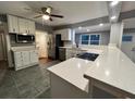 Modern kitchen with stainless steel appliances, white cabinetry, and stone countertops at 4900 Grand Ave, De Leon Springs, FL 32130