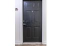 A condo's dark entry door featuring a peephole, stylish door knocker, and unit number at 5550 E Michigan St # 3309, Orlando, FL 32822