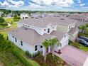 Aerial view of a suburban neighborhood showcasing the home's landscaping, roof, and surrounding properties at 603 Fortuna Dr, Davenport, FL 33837