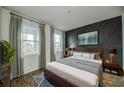 Cozy bedroom features wood floors, stylish wall art, and plenty of natural light from the large windows at 603 Fortuna Dr, Davenport, FL 33837
