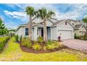 Beautiful home exterior featuring lush landscaping, manicured lawn, and a spacious two-car garage at 603 Fortuna Dr, Davenport, FL 33837
