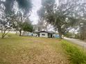 Spacious backyard with shed and mature trees, providing ample outdoor space at 701 S Delaware Ave, Deland, FL 32720