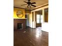 Living room featuring a brick fireplace and ceiling fan at 708 S Laurel Ave, Sanford, FL 32771