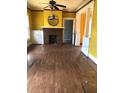 Living room featuring a ceiling fan and brick fireplace at 708 S Laurel Ave, Sanford, FL 32771