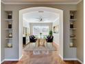 Dining room with an archway view, modern table and chairs, and decorative shelving niches at 8438 Diamond Cove Cir, Orlando, FL 32836