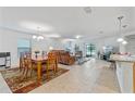 Bright and spacious living room with dining area featuring tile floors and sliding glass doors at 921 Emerald Green Ct, Kissimmee, FL 34746