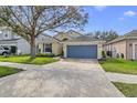 Inviting single-Gathering home with landscaped lawn and a blue two-car garage at 10286 Cypress Knee Cir, Orlando, FL 32825