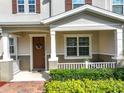 Charming front entrance with decorative wreath, porch, and well-manicured landscaping at 13730 Bravante Aly, Windermere, FL 34786